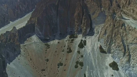 Sharp spacious highland scree slope, tourists trekking near crests cliffs, Nepal Stock Footage 124680089