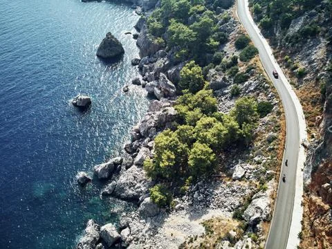 Sharp stones and rocks in the turquoise, blue sea. Drone aerial shot from above Stock Photos