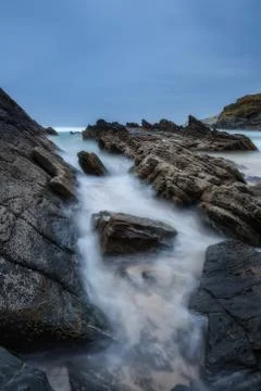 Sharp stones, rocks washed by the waves blurred. Stock Photos