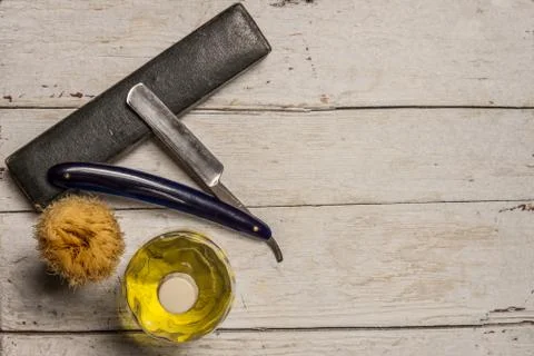 Sharp straight razor, brush and cologne aftershave Stock Photos