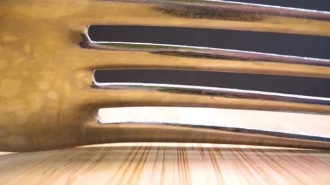 The sharp teeth of the silver fork on the table Видео 135702938