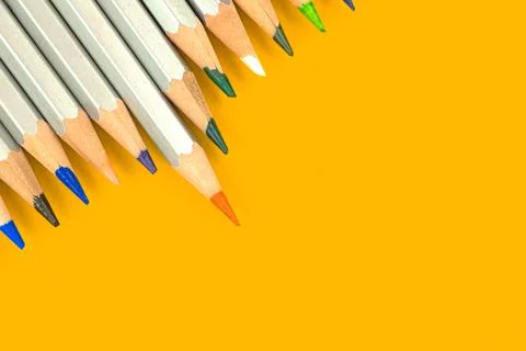 Sharp tips of school drawing pencils on a bright background. Education office Stock Photos
