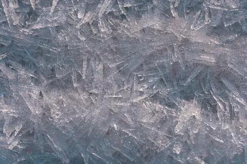 Sharp transparent ice crystal formations creating intricate geometric patte.. Stock Photos