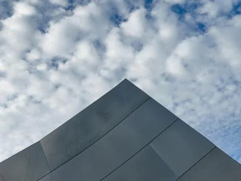 Sharp triangular metallic form points skyward like geometric pyramid Fotos de archivo