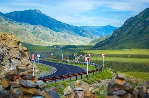 A sharp turn on a dangerous stretch of road, in the mountains. Stock Photos