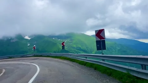 Sharp turns on a mountain road. Transfagarasan Highway. Cloud set on the road Stock Footage 251584215