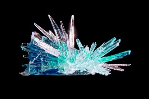 Sharp turquoise sapphire crystal highlighted from the bottom Stock Photos