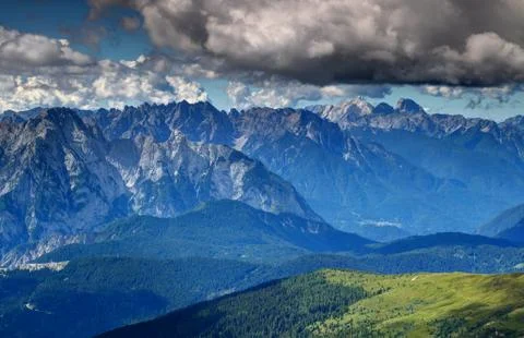 Sharp vertical Carnic Alps rock faces above Piave valley Italy Stock Photos