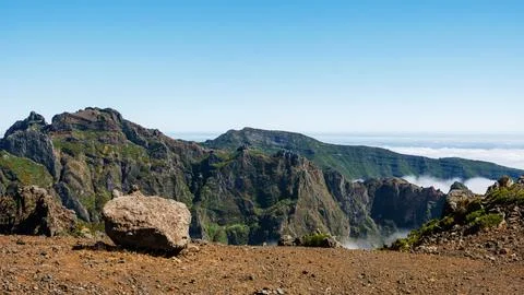 Sharp volcanic cliffs covered with shrubs at the summit of Pico do Arieiro,.. 库存照片