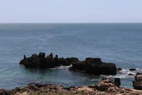 Sharp volcanic rock formations in the Atlantic Ocean, Cascais coastline Stock Photos