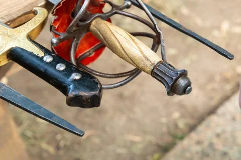 Sharp weapon of the sword of a medieval warrior and a hilt of a rapier Stock Photos