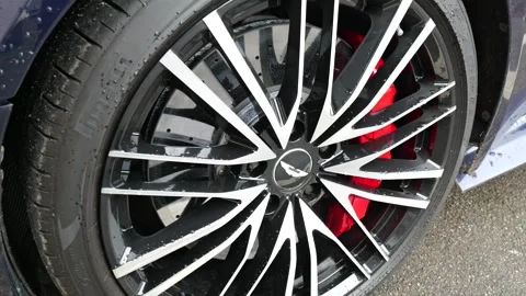 Sharp wheel black and silver multi spoke alloy rim wrapped pirelli rubber large Stock Footage 328211585