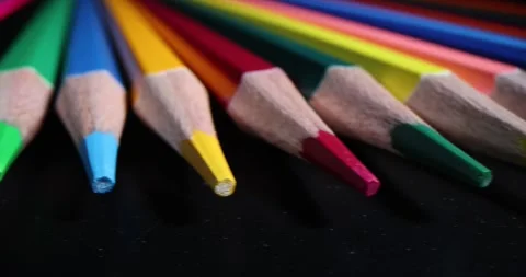 Sharp wooden multi-colored pencils on black background Stock Footage 244643952