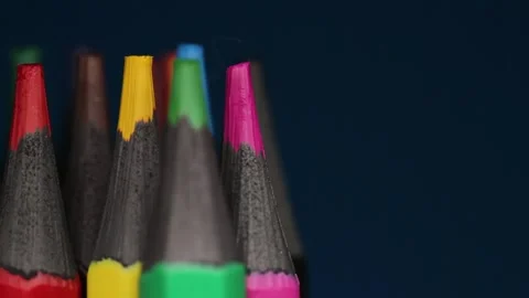 Sharp wooden multi-colored pencils on black background Stock Footage 250764445