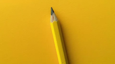 Sharp Yellow Pencil on Vibrant Yellow Background Stock Footage 279877210