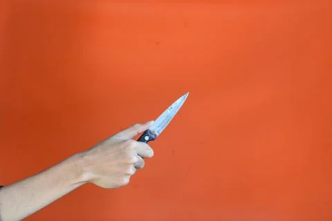 Sharp...don't touch it! Chef's kitchen knife isolated on orange background,.. Foto stock