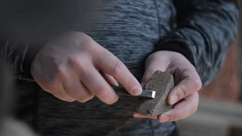 Сharpen the chisel with  hands to work with stone, Crossstone Video stock 142378140