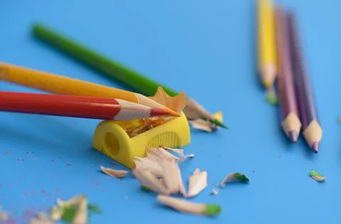 Sharpen the colored pencils with a sharpener. Stock Photos