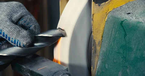 Sharpen drill bits on a bench grinder, close up. Stock Footage 170597174
