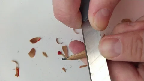 Sharpen a pencil with a knife Stock Footage 125974337
