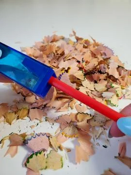 Sharpen the red pencil. A pencil sharpener sharpened a red pencil Stock Photos
