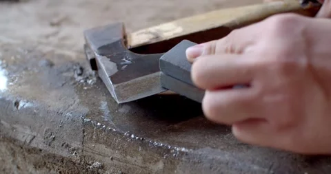 Sharpen your axe to make it look like new. Remove rust from an axe. Stock Footage 285612745