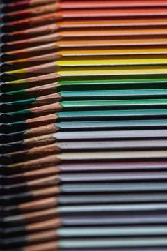 Sharpened colored pencils in warm tones arranged diagonally Stock Photos