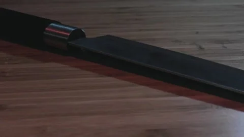 Sharpened knife turning red lights reflection Stock Footage 130698123