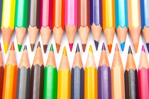 Sharpened multicolored pencils in a grid pattern. Suitable for art supplies.. Stock Photos