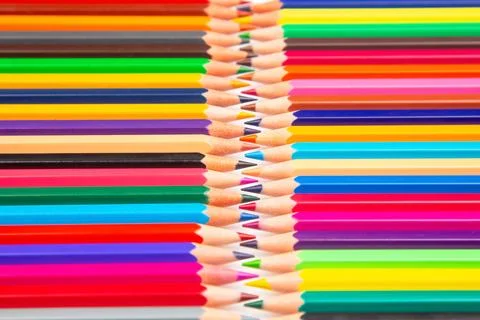 Sharpened multicolored pencils in a grid pattern. Suitable for art supplies.. Stock Photos