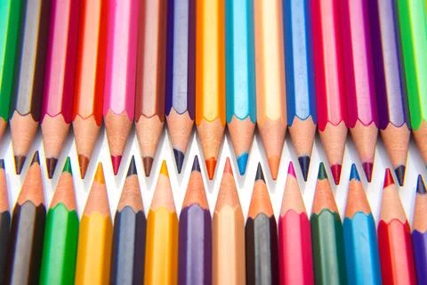 Sharpened multicolored pencils in a grid pattern. Suitable for art supplies.. Stock Photos