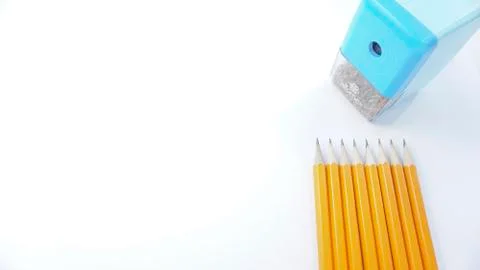 Sharpened pencils and sharpener are on a white background photo Stock Photos