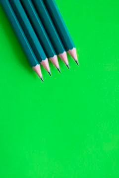 Sharpened pencils leing on green backgrond, top view Stock Photos