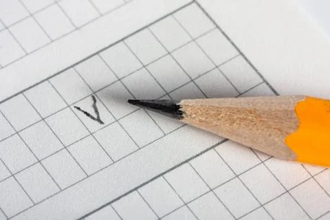 Sharpened yellow drawing pencil on sheet in check Sharpened yellow drawing... 스톡 사진