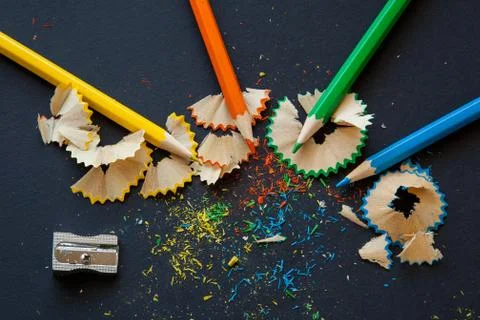 Sharpener and colored pencils on black (2) Stock Photos