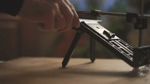 Sharpener for knives on a wooden table side view video Stock Footage 85798052