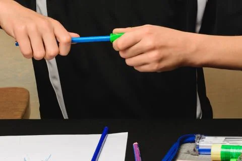 The sharpener sharpens his pencils for drawing. Stock Photos