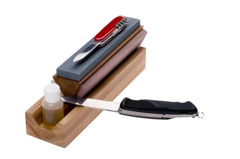 Sharpener stone and knife Stock Photos