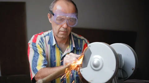 Sharpening axe using a grinding machine Stock Footage 67578231