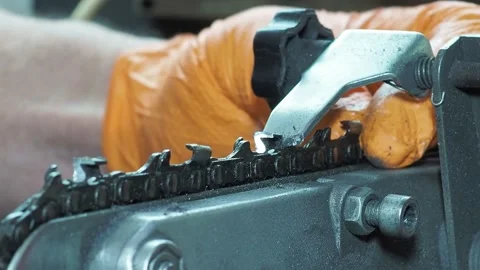 Sharpening chainsaw with abrasive disc from rigth side. Closeup shot Stock Footage 171216333