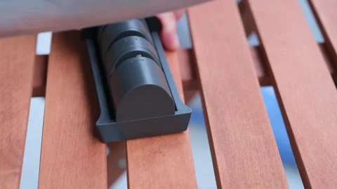 Sharpening chef knife with knife sharpener on table Stock Footage 262078284