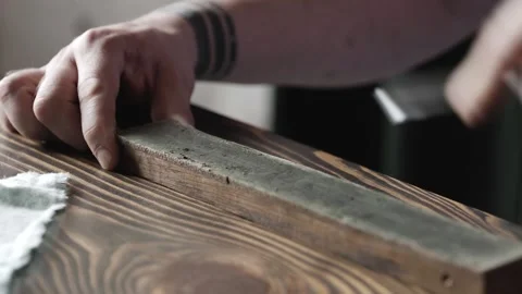 Sharpening a chisel with felt. woodworking process with hand tools in a carpe Stock Footage 166082051