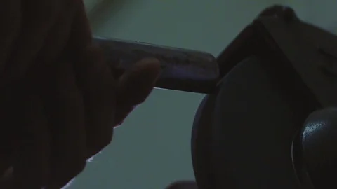 Sharpening a chisel Stock Footage 83496319