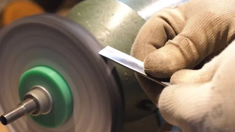 Sharpening a chisel on grinding machine Stock Footage 84663368