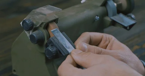 Sharpening A Chisel On Grinding Machine With Sparks Fly . Cinema 4K Video Stock Footage 121975798