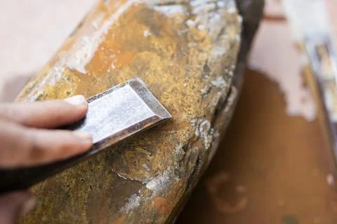 Sharpening a chisel on a wet stone Stock Photos