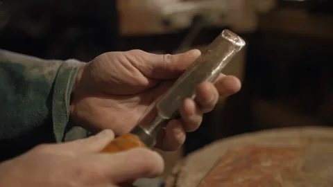 Sharpening a chisel with a whetstone Stock Footage 169156774