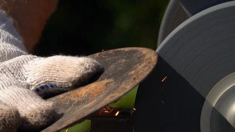 Sharpening of garden tool with unbalanced grinding machine in slow motion. Stock Footage 98677543