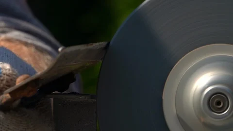Sharpening of grange garden tool with unbalanced grinding machine in slow motion Stock Footage 98677710