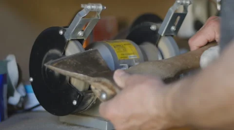 Sharpening hatchet with tool grinder Stock Footage 58602811